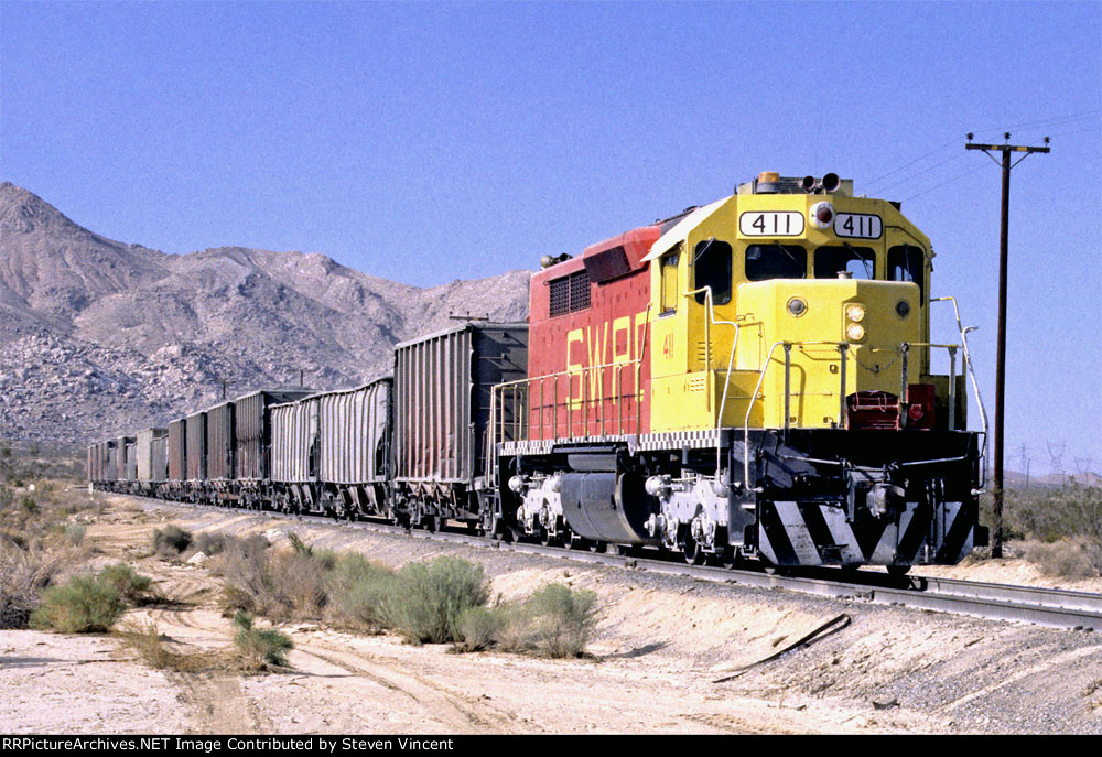Southwest Portland Cement SDP35 SWPC #411 eases train down final grade into the company yard 